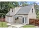 View of the home's rear exterior featuring a door to the backyard patio at 4709 Tyne Dr, Durham, NC 27703