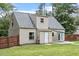 View of the home's rear exterior featuring a door to the backyard patio at 4709 Tyne Dr, Durham, NC 27703
