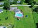 An aerial view of a community pool with chairs, surrounded by lush greenery and well-maintained grounds at 5013 Wheatridge Dr, Fuquay Varina, NC 27526