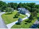 An aerial view showcases the home's well-manicured lawn and driveway at 5013 Wheatridge Dr, Fuquay Varina, NC 27526