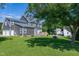 Large home with lush green backyard, tree coverage, and multi-car garage at 5013 Wheatridge Dr, Fuquay Varina, NC 27526