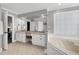 Bathroom showcasing a double vanity, soaking tub, and ample natural light at 5013 Wheatridge Dr, Fuquay Varina, NC 27526