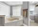 Bright bathroom with a built-in tub, tile floors, and a neutral color palette at 5013 Wheatridge Dr, Fuquay Varina, NC 27526