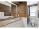 Bathroom featuring wood paneling, granite countertop, and modern fixtures at 5013 Wheatridge Dr, Fuquay Varina, NC 27526
