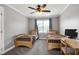Bright and spacious bedroom with two twin beds, ceiling fan, and a study desk at 5013 Wheatridge Dr, Fuquay Varina, NC 27526