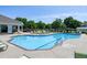 A community pool with a variety of chairs, with a clear blue pool, and lush greenery around the pool at 5013 Wheatridge Dr, Fuquay Varina, NC 27526