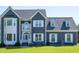 The exterior of a two-story home is shown with gray siding and white trim at 5013 Wheatridge Dr, Fuquay Varina, NC 27526