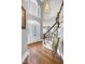 The foyer boasts hardwood floors, stairs, a chandelier, and a decorative front door at 5013 Wheatridge Dr, Fuquay Varina, NC 27526