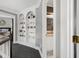 Hallway with built-in shelving leads to a bathroom and bedroom at 5013 Wheatridge Dr, Fuquay Varina, NC 27526