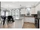 The bright kitchen features an island, granite counters, and stainless steel appliances at 5013 Wheatridge Dr, Fuquay Varina, NC 27526