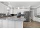 A kitchen features white cabinets, granite countertops, and stainless-steel appliances at 5013 Wheatridge Dr, Fuquay Varina, NC 27526