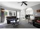 The open-concept living room features gray walls and dark leather furniture at 5013 Wheatridge Dr, Fuquay Varina, NC 27526