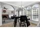 Open-concept living space featuring a fireplace, large windows, and modern decor at 5013 Wheatridge Dr, Fuquay Varina, NC 27526