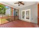 Cozy back porch features stained wood flooring, ceiling fan, and screened windows offering outdoor relaxation at 509 Holden Forest Dr, Youngsville, NC 27596