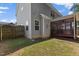 Backyard view showcasing the house's siding, windows, and a screened-in porch, complemented by a grassy lawn at 509 Holden Forest Dr, Youngsville, NC 27596