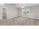 Bright bedroom with plush carpeting, a ceiling fan, and a large window providing plenty of natural light at 509 Holden Forest Dr, Youngsville, NC 27596