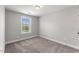 Cozy bedroom with plush carpet, a window providing natural light, and neutral walls creating a serene atmosphere at 509 Holden Forest Dr, Youngsville, NC 27596