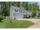 Two-story home with a two-car garage, green lawn, and gray exterior at 509 Holden Forest Dr, Youngsville, NC 27596