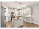 Modern kitchen with white cabinets, granite countertops, and stainless steel appliances at 509 Holden Forest Dr, Youngsville, NC 27596