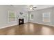 Open living room with a fireplace, hardwood floors, and lots of natural light at 509 Holden Forest Dr, Youngsville, NC 27596