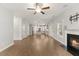 Open living room and kitchen with a fireplace, hardwood floors, and light gray walls at 509 Holden Forest Dr, Youngsville, NC 27596