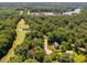 Aerial view showing the golf course near the lake with houses nestled in the trees at 5109 Windance Pl, Holly Springs, NC 27540