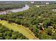 High-angle shot capturing the golf course, lake, and neighborhood amenities within a wooded environment at 5109 Windance Pl, Holly Springs, NC 27540