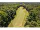 Aerial view of the lush golf course winding through a wooded area showing beautiful landscaping and well manicured greenery at 5109 Windance Pl, Holly Springs, NC 27540