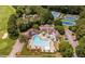 Aerial view featuring the sparkling community pool, tennis courts, and surrounding amenities at 5109 Windance Pl, Holly Springs, NC 27540