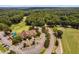 Aerial shot showcasing the clubhouse, parking area, and the beginning of the golf course at 5109 Windance Pl, Holly Springs, NC 27540