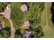Aerial perspective of homes nestled among the trees and adjacent to the golf course and winding neighborhood streets at 5109 Windance Pl, Holly Springs, NC 27540