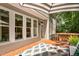 Cozy back deck with ample seating, an umbrella, and access to the home's interior at 5109 Windance Pl, Holly Springs, NC 27540