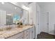 Elegant bathroom boasts a granite countertop with dual sinks and modern fixtures at 5109 Windance Pl, Holly Springs, NC 27540