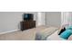 Spacious bedroom features a dresser with TV and neutral carpet at 5109 Windance Pl, Holly Springs, NC 27540