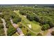 An aerial shot displays a lush golf course with trees, sand traps, and a glimpse of a home at 5109 Windance Pl, Holly Springs, NC 27540