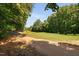 Scenic view of the golf course with a walking path alongside lush green fairways surrounded by mature trees at 5109 Windance Pl, Holly Springs, NC 27540