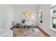 Bright home office with hardwood floors, desk, a gold world map, rug, and plenty of natural light at 5109 Windance Pl, Holly Springs, NC 27540
