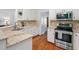 Modern kitchen with stainless steel oven and sink, granite countertops, and updated cabinets at 5109 Windance Pl, Holly Springs, NC 27540