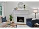 Inviting living room with fireplace, white mantel, hardwood floors, and comfortable seating at 5109 Windance Pl, Holly Springs, NC 27540