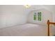 Carpeted bedroom with large windows and a closet, featuring natural light and cozy ambiance at 5205 Coffeetree Dr, Raleigh, NC 27613