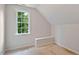 Bedroom featuring carpeted floors, sloped ceilings, and a window for natural light at 5205 Coffeetree Dr, Raleigh, NC 27613