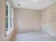 Neutral bedroom with soft carpet, bright windows and a white paneled closet door at 5205 Coffeetree Dr, Raleigh, NC 27613