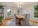 Classic dining room boasting wood flooring, large windows, and comfortable seating for formal meals at 5205 Coffeetree Dr, Raleigh, NC 27613