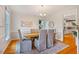 Cozy dining room with wood floors, neutral walls, and views to the kitchen at 5205 Coffeetree Dr, Raleigh, NC 27613