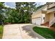 Long driveway with basketball hoop leading to the two car garage at 5205 Coffeetree Dr, Raleigh, NC 27613