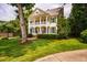 Charming two-story home with a classic design, featuring a well-kept lawn and mature trees at 5205 Coffeetree Dr, Raleigh, NC 27613