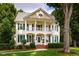 Stunning two-story home with a charming front porch and meticulously landscaped front yard at 5205 Coffeetree Dr, Raleigh, NC 27613