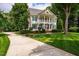 Beautiful two-story house boasting a welcoming front porch, complemented by a well-manicured lawn at 5205 Coffeetree Dr, Raleigh, NC 27613