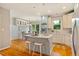 Beautiful updated kitchen with white cabinets, marble countertops, and center island at 5205 Coffeetree Dr, Raleigh, NC 27613