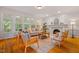 Cozy living room featuring a fireplace, hardwood floors, and large windows at 5205 Coffeetree Dr, Raleigh, NC 27613